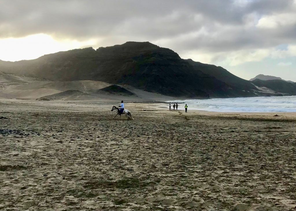 Cabo Verde man on horseback on the beach